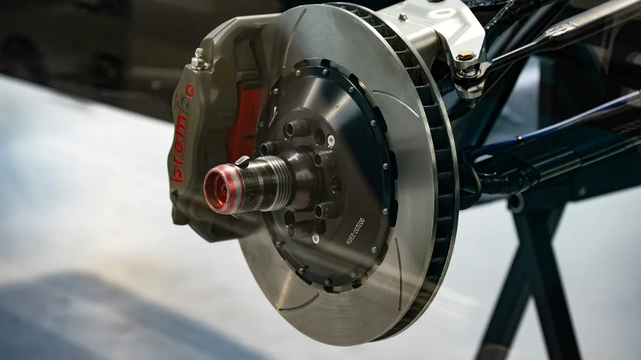 A close-up of a vented brake rotor and caliper on a vehicle